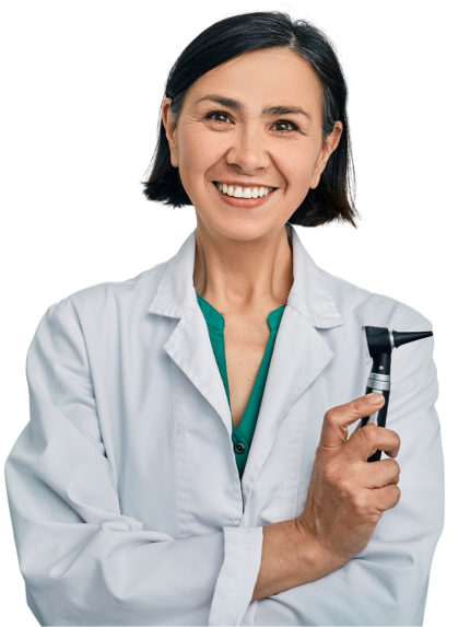 A photo of a dark-haired female audiologist in a white lab coat holding an otoscope with her arms crossed and smiling.